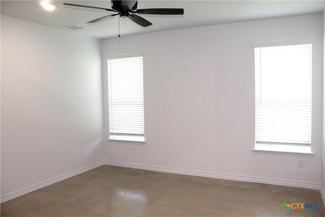 unfurnished room with ceiling fan and a healthy amount of sunlight