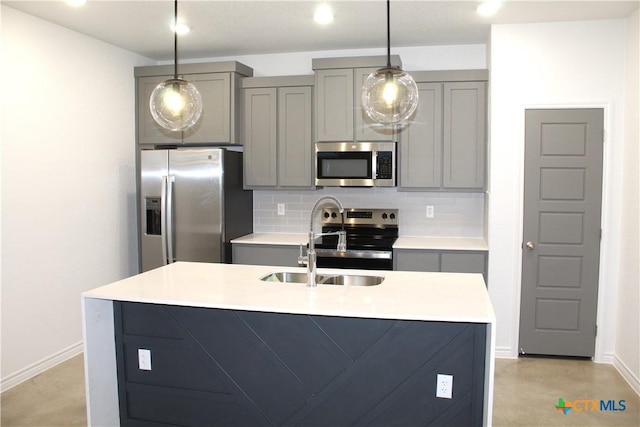 kitchen featuring decorative backsplash, sink, gray cabinetry, and stainless steel appliances