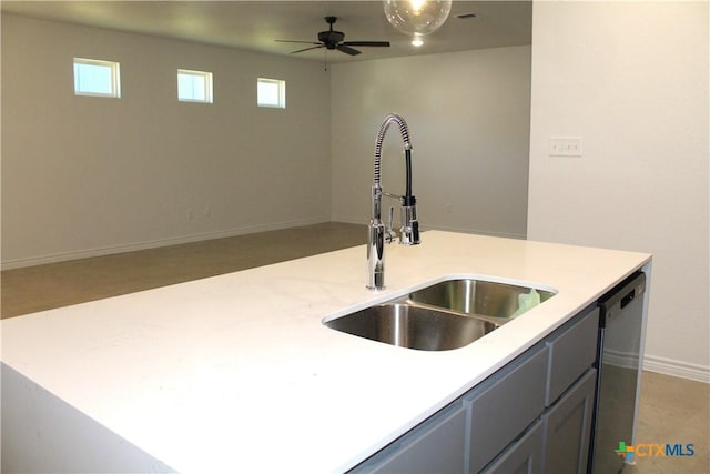 kitchen featuring dishwasher, ceiling fan, sink, gray cabinets, and a center island with sink