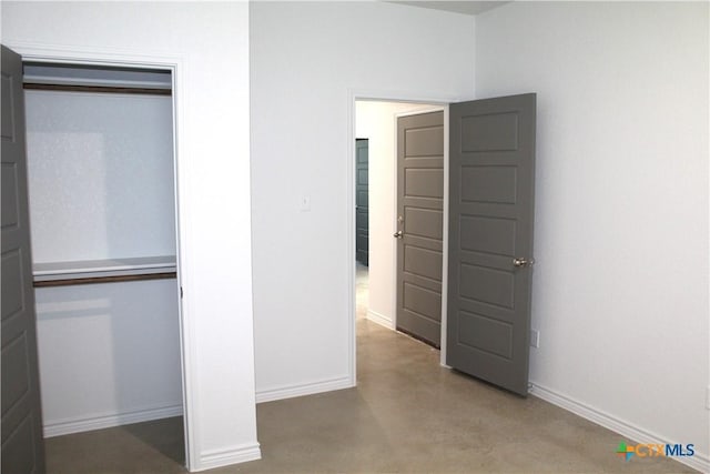 interior space with a closet and concrete floors