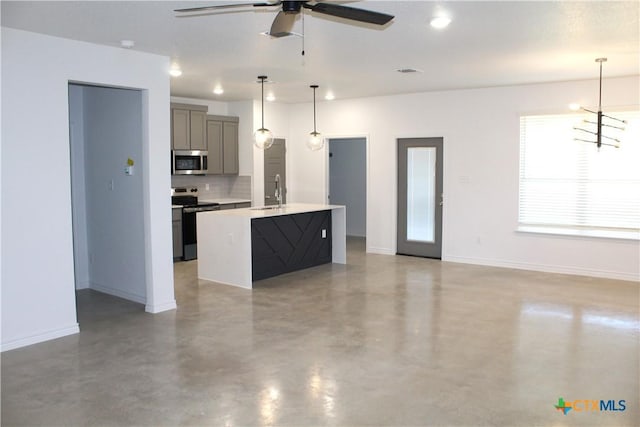 kitchen with backsplash, gray cabinetry, concrete floors, a kitchen island with sink, and stainless steel appliances