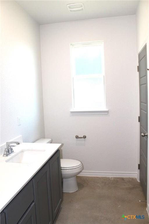 bathroom featuring concrete floors, toilet, and vanity