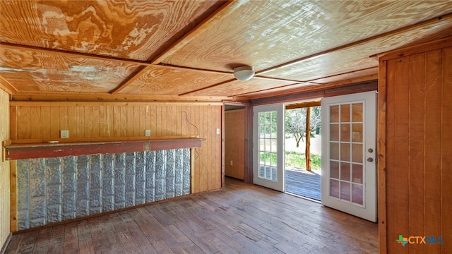 interior space featuring wood walls, wood ceiling, hardwood / wood-style floors, and french doors