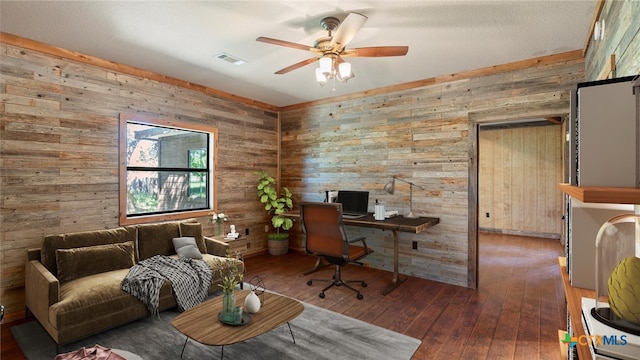 office space featuring dark wood-type flooring, wooden walls, and ceiling fan