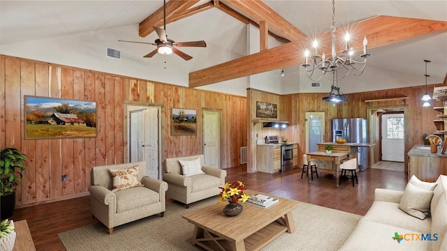 living room with dark wood-type flooring, beam ceiling, and wooden walls