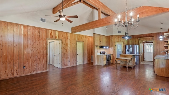 kitchen with stainless steel appliances, sink, dark hardwood / wood-style floors, beam ceiling, and decorative light fixtures