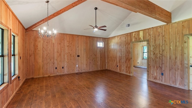 empty room with ceiling fan with notable chandelier, dark hardwood / wood-style flooring, wood walls, high vaulted ceiling, and beam ceiling