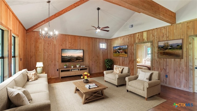 living room featuring beamed ceiling, wooden walls, wood-type flooring, and plenty of natural light