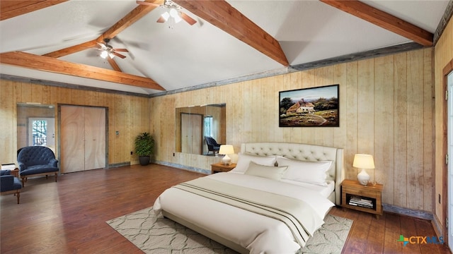 bedroom featuring dark hardwood / wood-style flooring, wooden walls, and ceiling fan