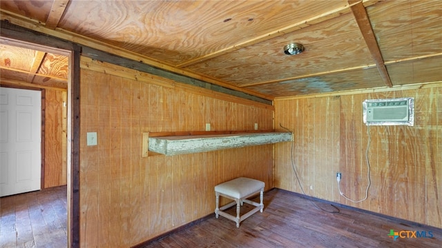 interior space with a wall unit AC, wooden walls, indoor bar, and dark hardwood / wood-style floors