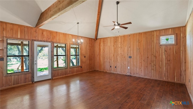 unfurnished room with lofted ceiling with beams, dark hardwood / wood-style flooring, wooden walls, and ceiling fan with notable chandelier