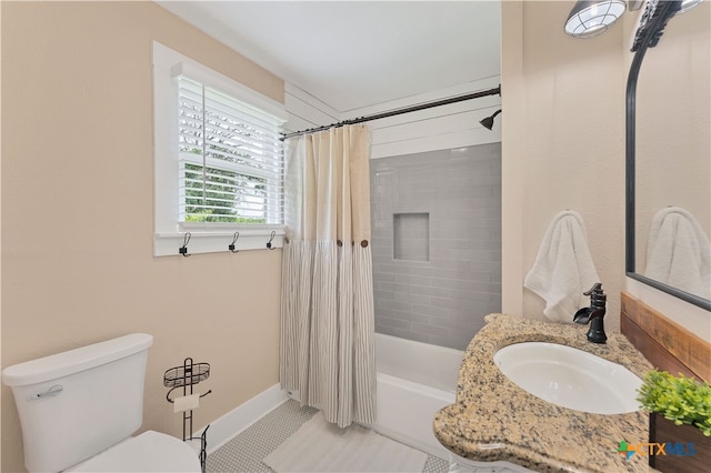 full bathroom featuring vanity, shower / bath combo with shower curtain, tile patterned flooring, and toilet