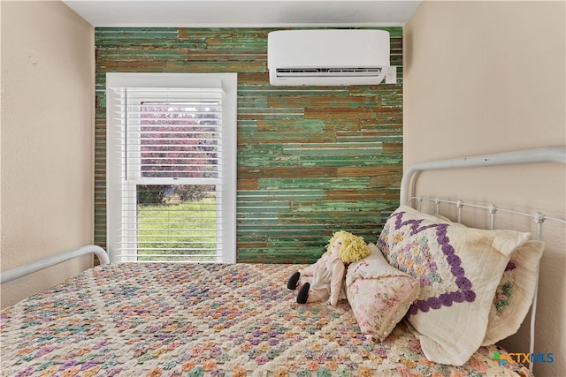 bedroom with a wall mounted AC and multiple windows