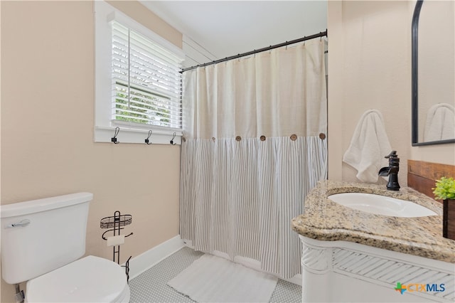 bathroom featuring toilet, vanity, and tile patterned floors