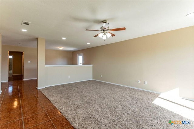 tiled empty room featuring ceiling fan