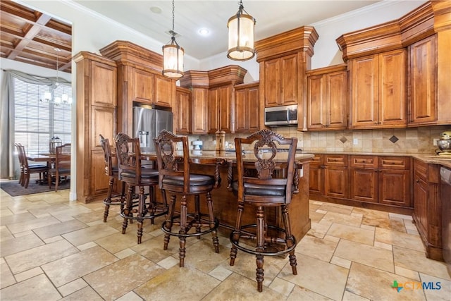 kitchen featuring a breakfast bar, backsplash, stainless steel appliances, light stone counters, and decorative light fixtures