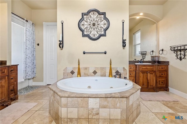 bathroom featuring vanity, tiled tub, and tile patterned floors