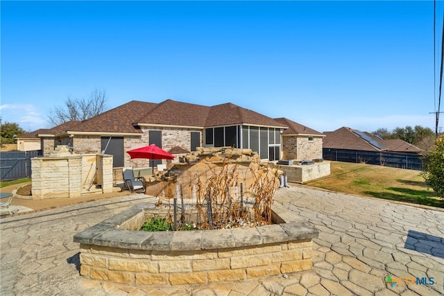 view of front facade with area for grilling, a fireplace, and a patio area