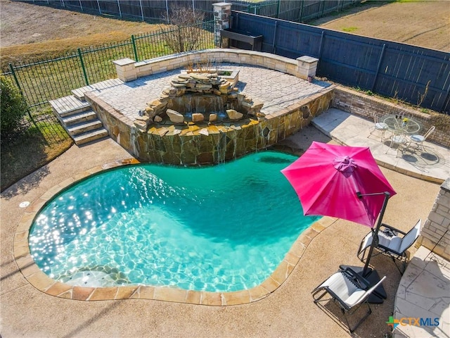 view of swimming pool with an outdoor fire pit and a patio area