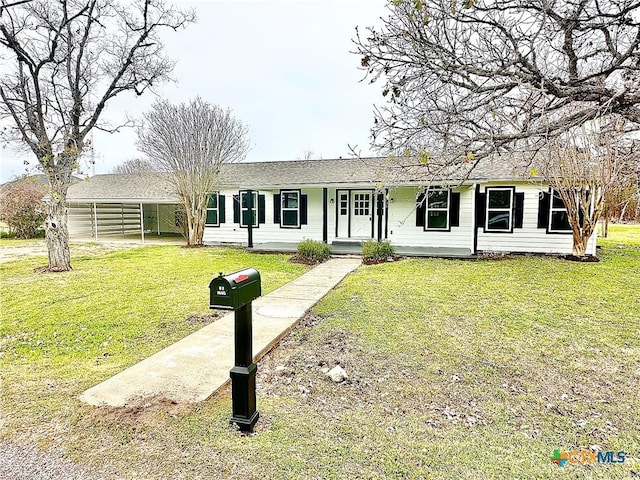 ranch-style home with a front lawn and a carport