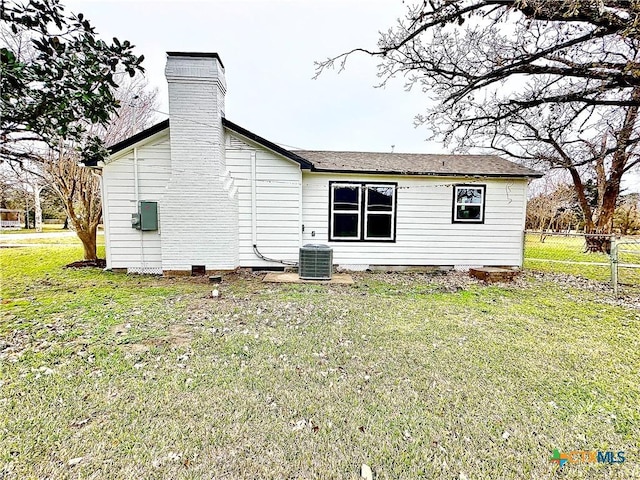 view of home's exterior with central AC unit and a yard