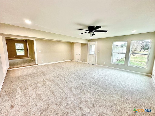 spare room featuring ceiling fan and carpet flooring