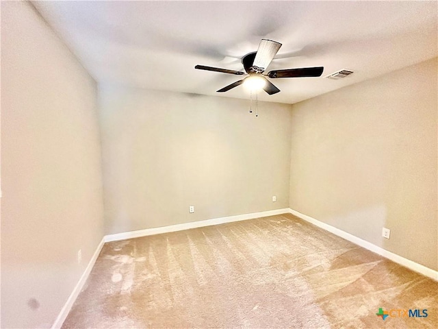 carpeted spare room featuring ceiling fan