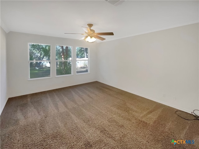 empty room featuring carpet and ceiling fan