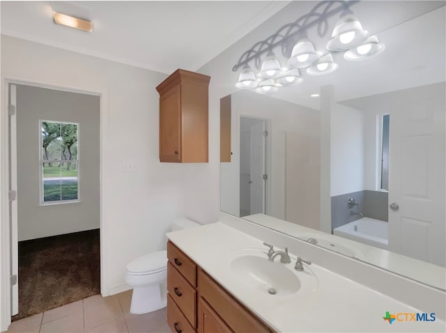 bathroom with ornamental molding, vanity, a bathing tub, tile patterned floors, and toilet