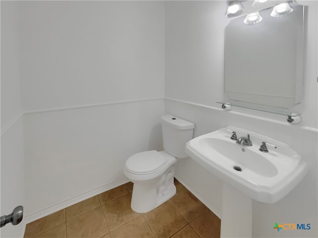 bathroom with tile patterned flooring and toilet