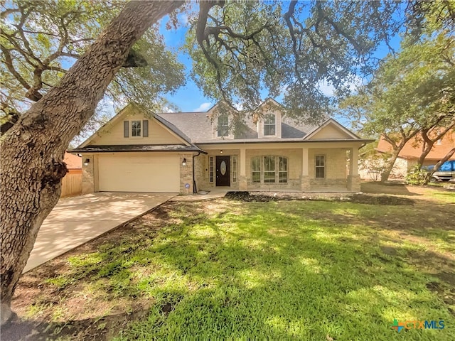 view of front of home with a garage, a porch, and a front yard