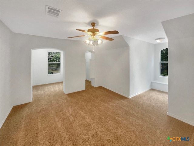 additional living space with ceiling fan and light carpet