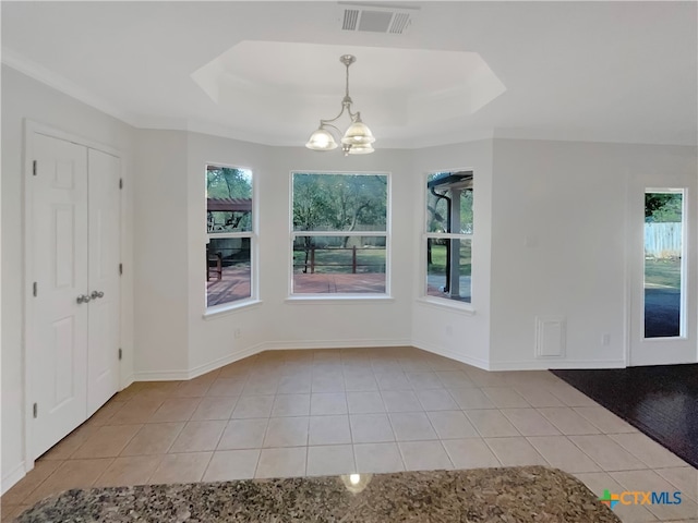 unfurnished dining area with a tray ceiling, a chandelier, and light tile patterned flooring