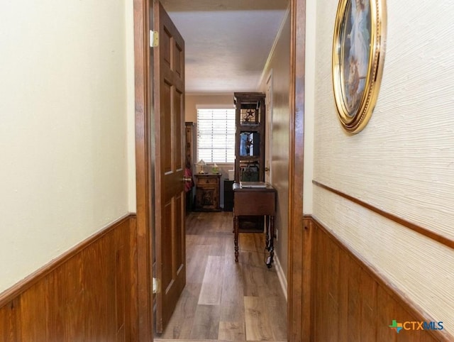 3309 Cottonwood Ln, Temple, TX 76502 - corridor featuring a wainscoted wall, wood walls, and wood finished floors