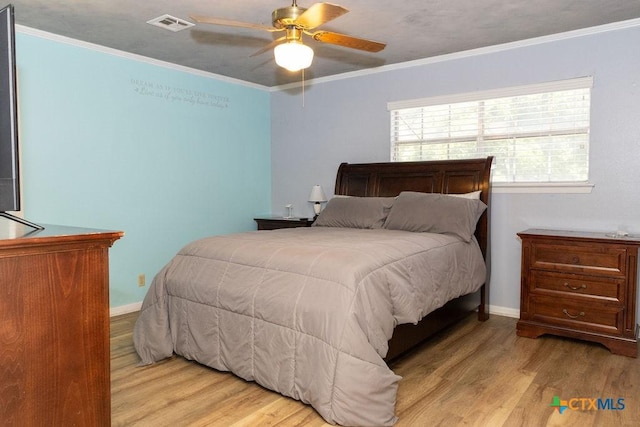 3309 Cottonwood Ln, Temple, TX 76502 - bedroom with wood finished floors, crown molding, and a ceiling fan