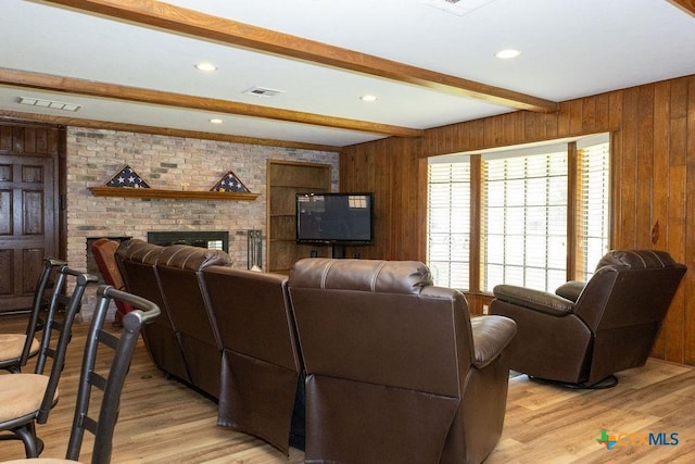 3309 Cottonwood Ln, Temple, TX 76502 - living area featuring beam ceiling, light wood-style flooring, a brick fireplace, wooden walls, and recessed lighting