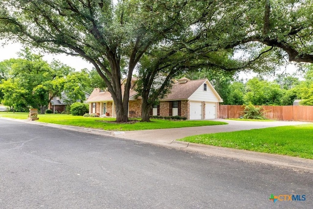3309 Cottonwood Ln, Temple, TX 76502 - view of property hidden behind natural elements with a garage, driveway, and brick siding