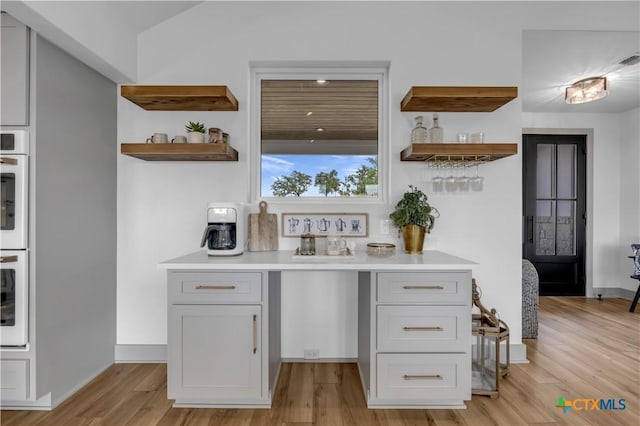 438 Cedar Mountain Dr, Marble Falls, TX 78654 - indoor bar with light wood finished floors, baseboards, and double oven