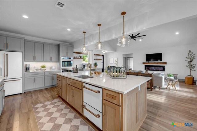438 Cedar Mountain Dr, Marble Falls, TX 78654 - kitchen featuring white appliances, a sink, recessed lighting, light countertops, and light wood-style floors