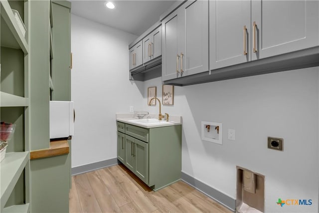 438 Cedar Mountain Dr, Marble Falls, TX 78654 - laundry area featuring electric dryer hookup, light wood finished floors, hookup for a washing machine, cabinet space, and recessed lighting