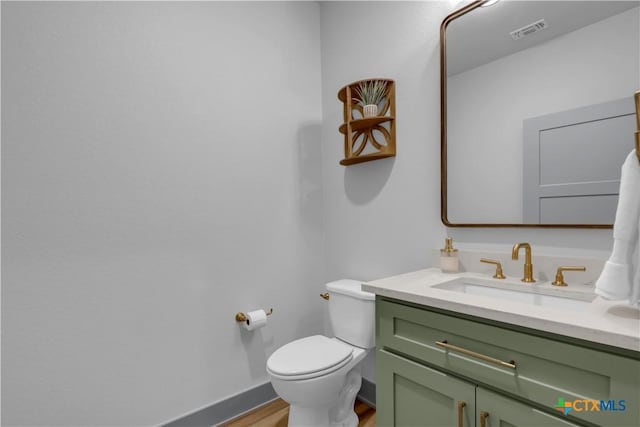 438 Cedar Mountain Dr, Marble Falls, TX 78654 - half bath with vanity, wood finished floors, toilet, and baseboards