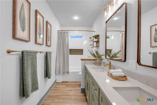 438 Cedar Mountain Dr, Marble Falls, TX 78654 - full bathroom with wood finished floors, double vanity, shower / bath combination with curtain, and toilet