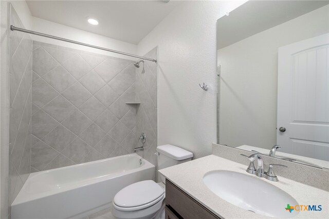 full bathroom with vanity, toilet, and tiled shower / bath