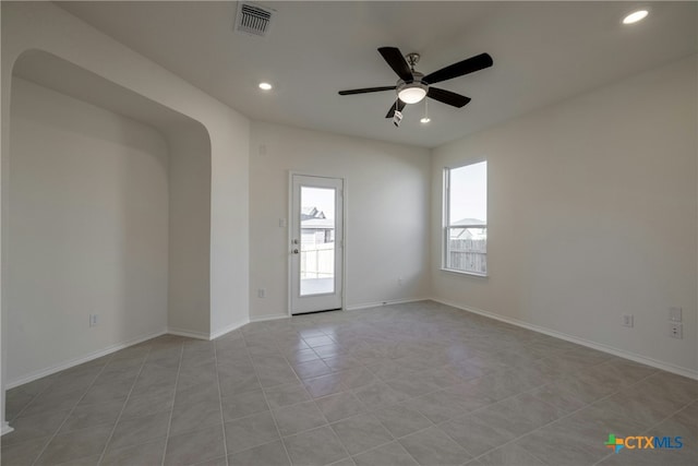 tiled empty room with ceiling fan