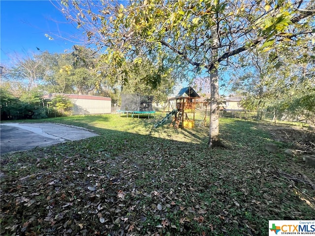 view of yard featuring a playground, a patio, and a trampoline