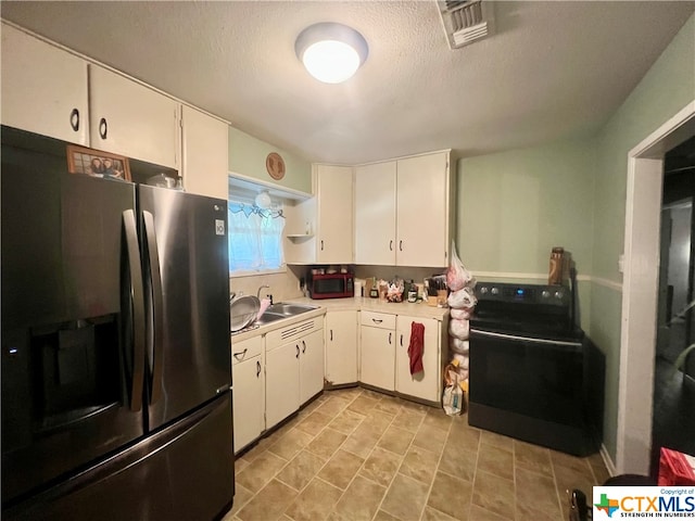 kitchen featuring white cabinetry, a textured ceiling, black appliances, and sink