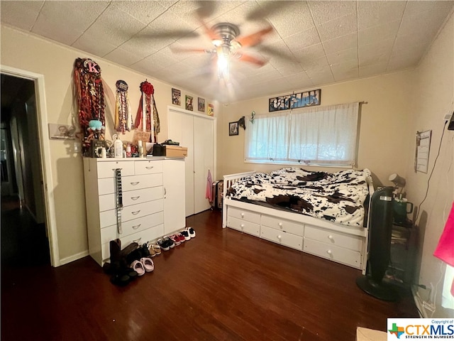 bedroom featuring ceiling fan and dark hardwood / wood-style flooring