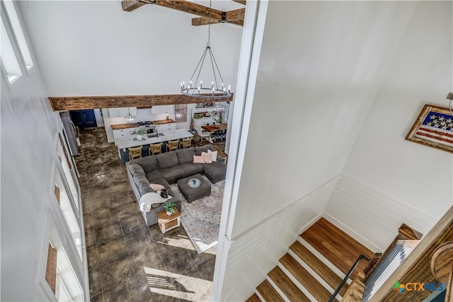 stairs with hardwood / wood-style flooring and a notable chandelier