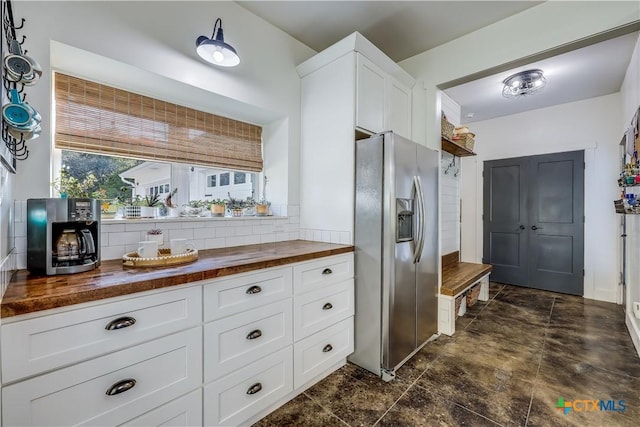 kitchen featuring butcher block countertops, white cabinets, and stainless steel fridge with ice dispenser