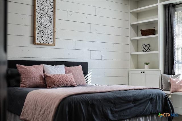 bedroom with wood walls